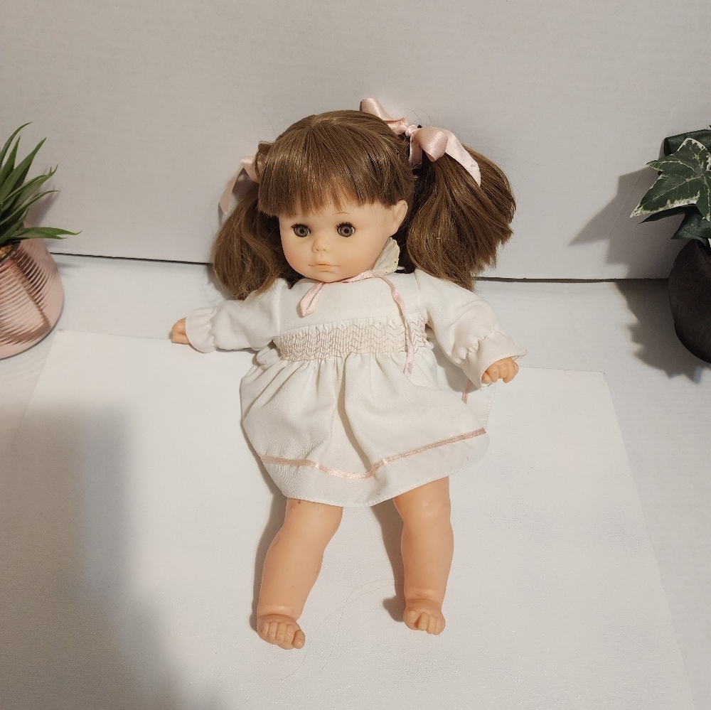 Vintaje Adorable Brown-Haired Doll with Pink Accents